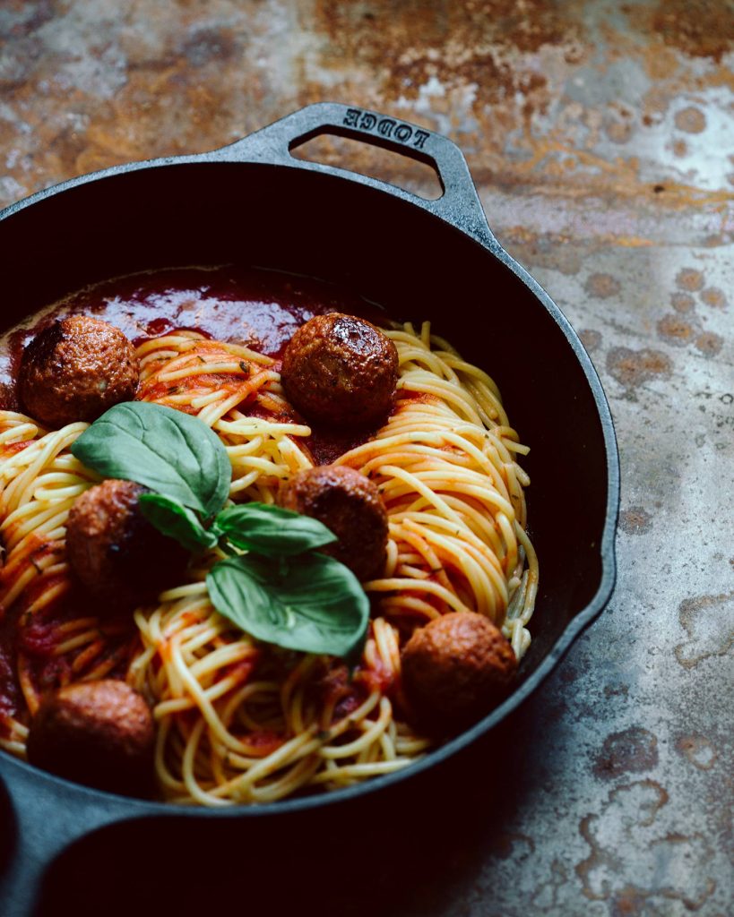 Vegane Meatballs mit Spaghetti in pikanter Tomatensauce auf Teller serviert