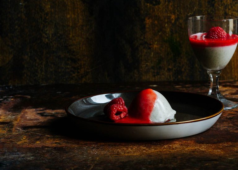 Vegane Kokos Panna Cotta im Glas mit rotem Himbeerspiegel
