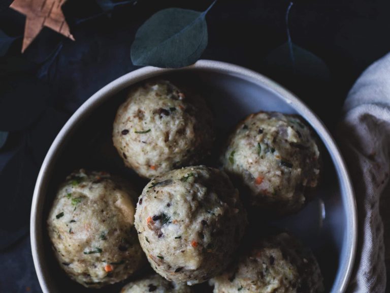 Vegane Semmelknödel auf einem Teller, serviert als klassische pflanzliche Beilage.